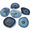 Six blue agate slice coasters arranged on a plain white background. Each coaster is made from a polished natural agate slice with concentric bands of dark navy, bright blue, and pale icy blue, with a greenish translucent center hole.