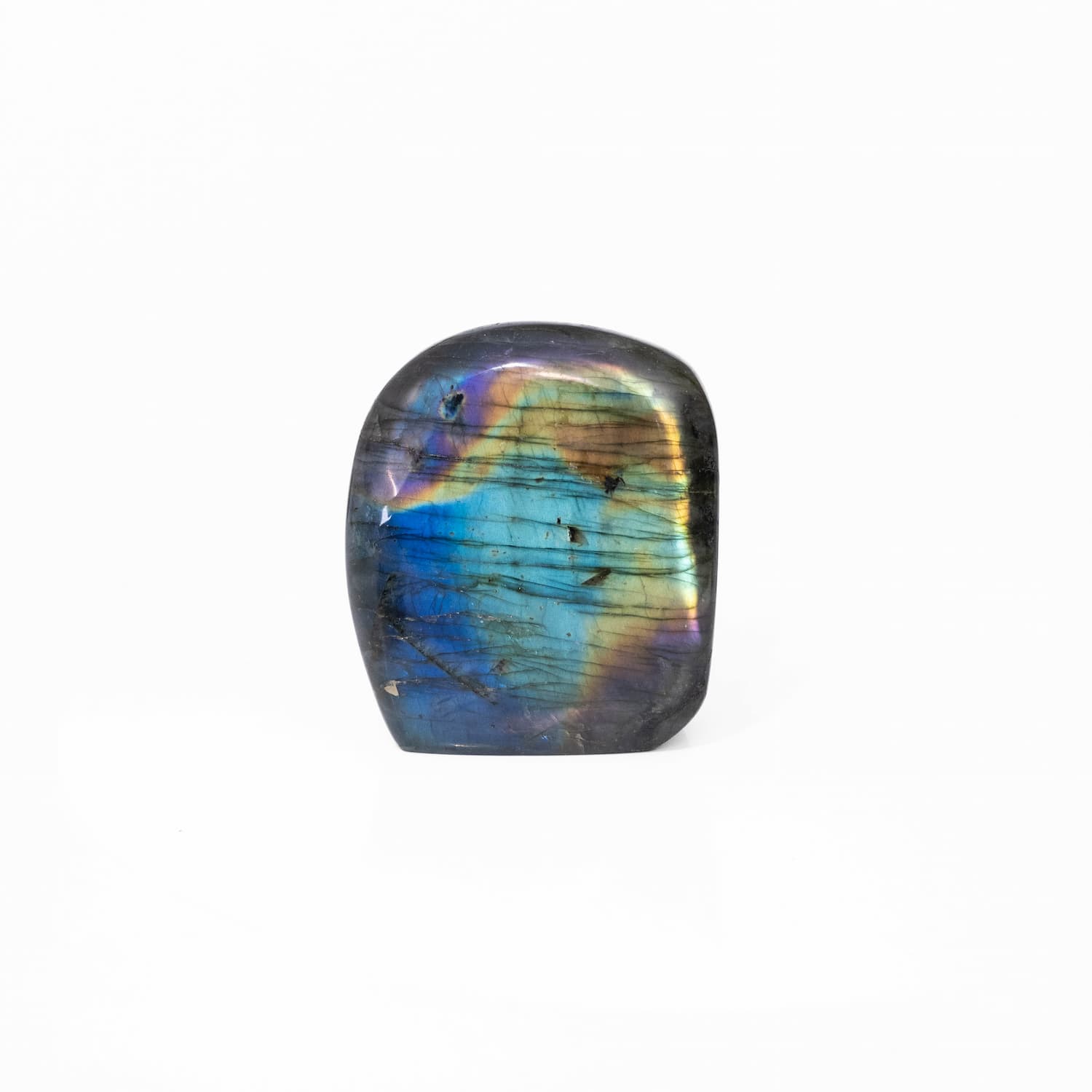 A polished labradorite stone Freeform with a smooth, rounded shape, showcasing a vibrant play-of-color with blue, green, gold, and purple iridescence on a clean white background.